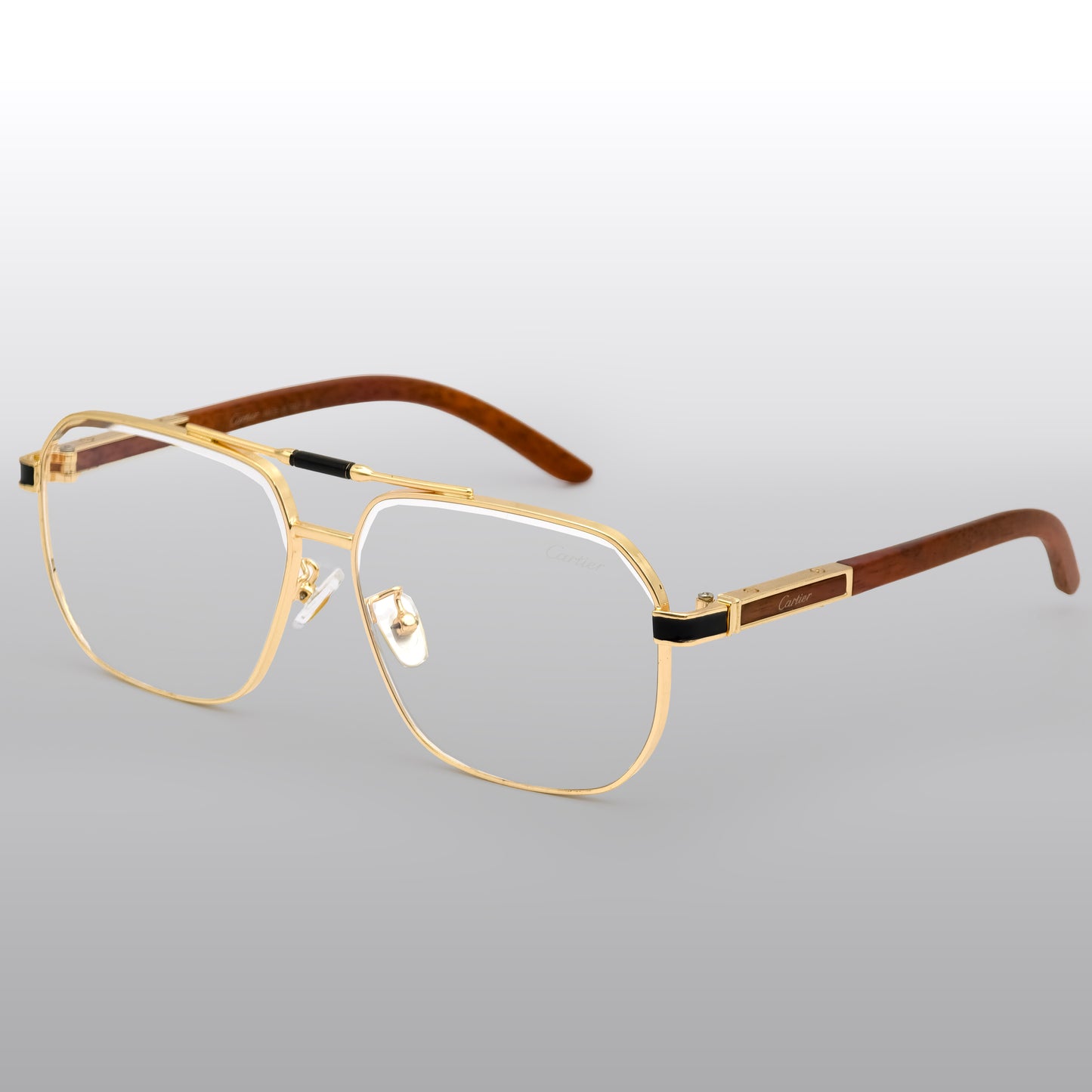 Gold-framed eyeglasses with wooden accents on a light gray background