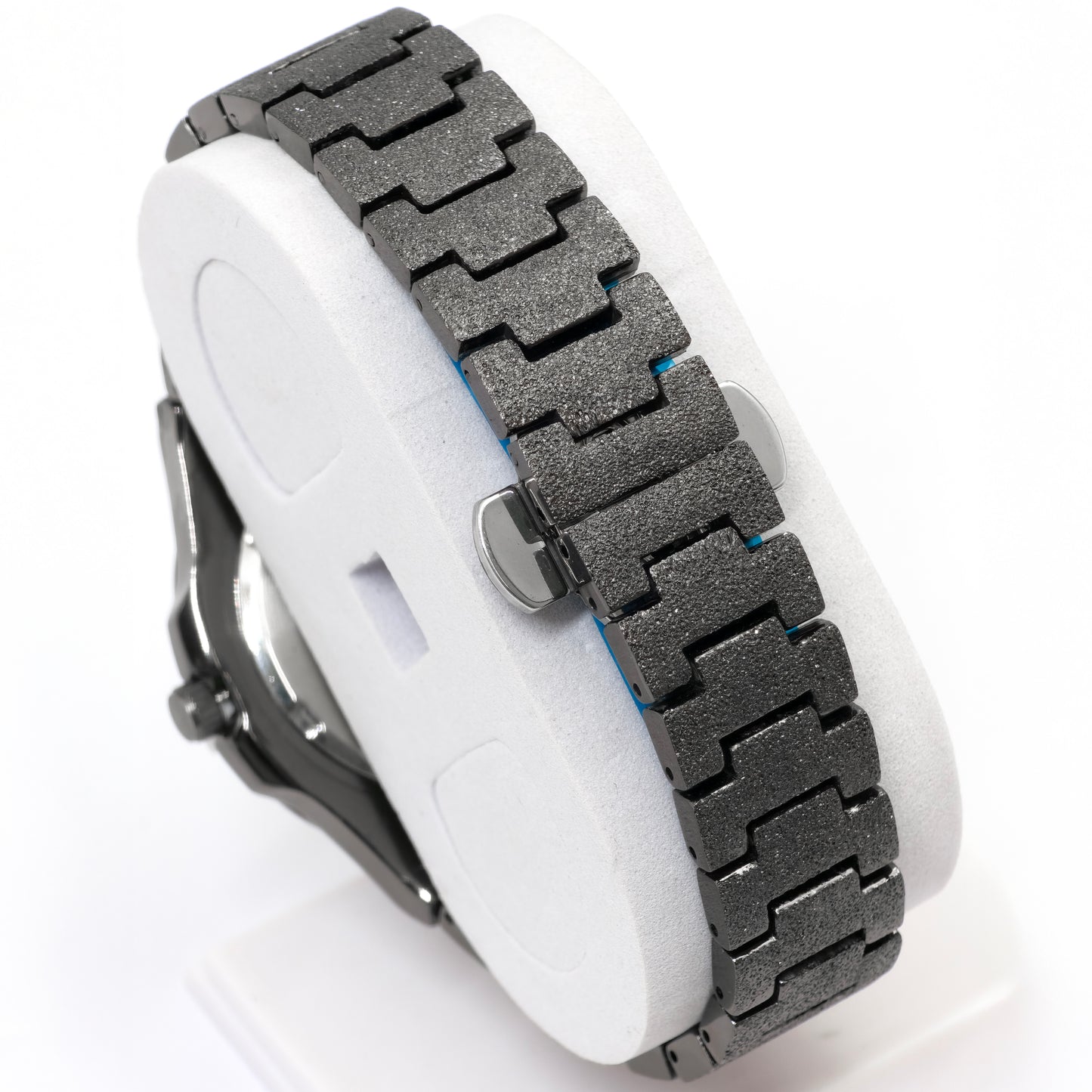 Close-up of a watch with a metallic band on a white background