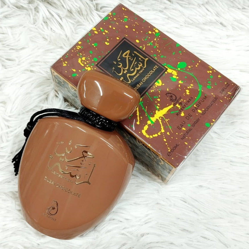 Brown ceramic item with decorative box on a white textured surface