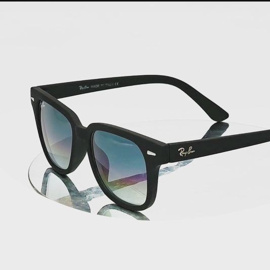 Black sunglasses with blue gradient lenses on a white background