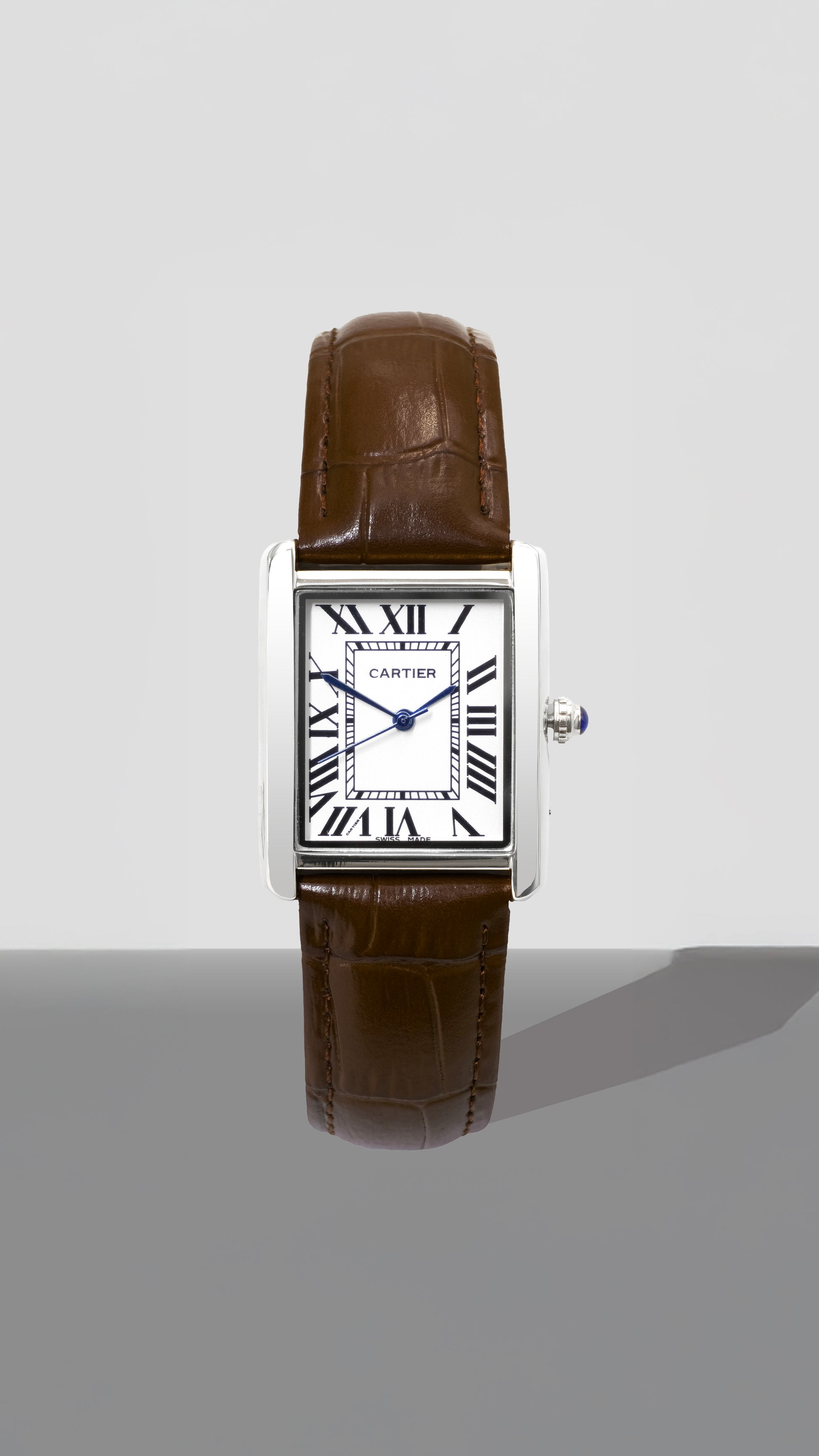 Cartier watch with brown leather strap on a white background