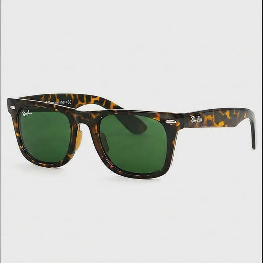 Sunglasses with tortoiseshell frame and green lenses on a white background