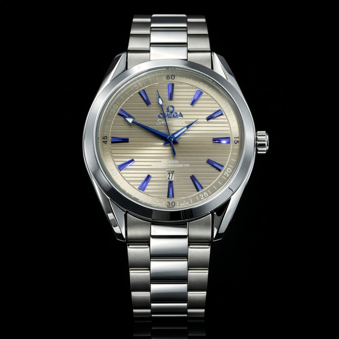 Silver watch with a detailed face on a black background