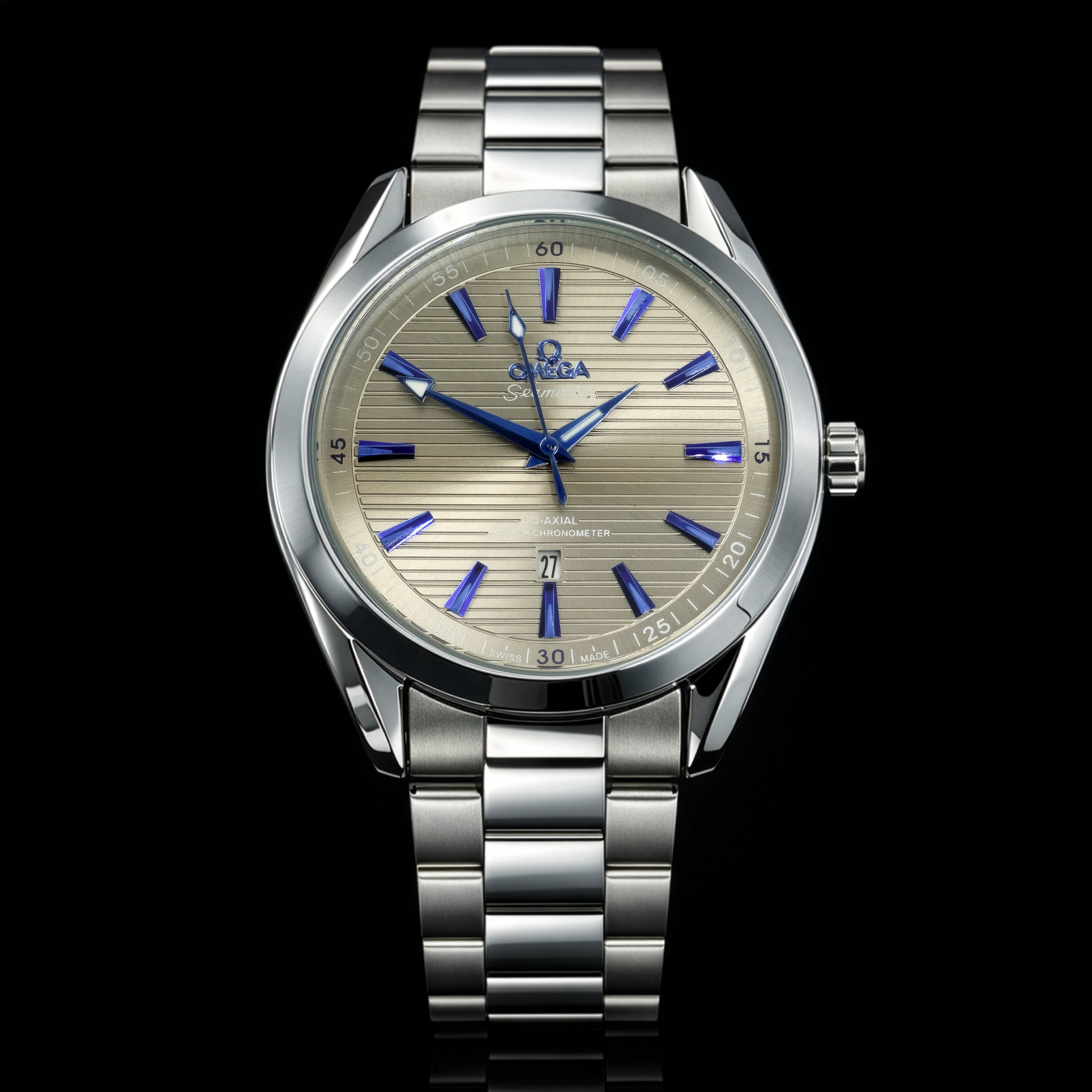 Silver watch with a detailed face on a black background
