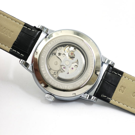 Watch with black and beige strap on a white background