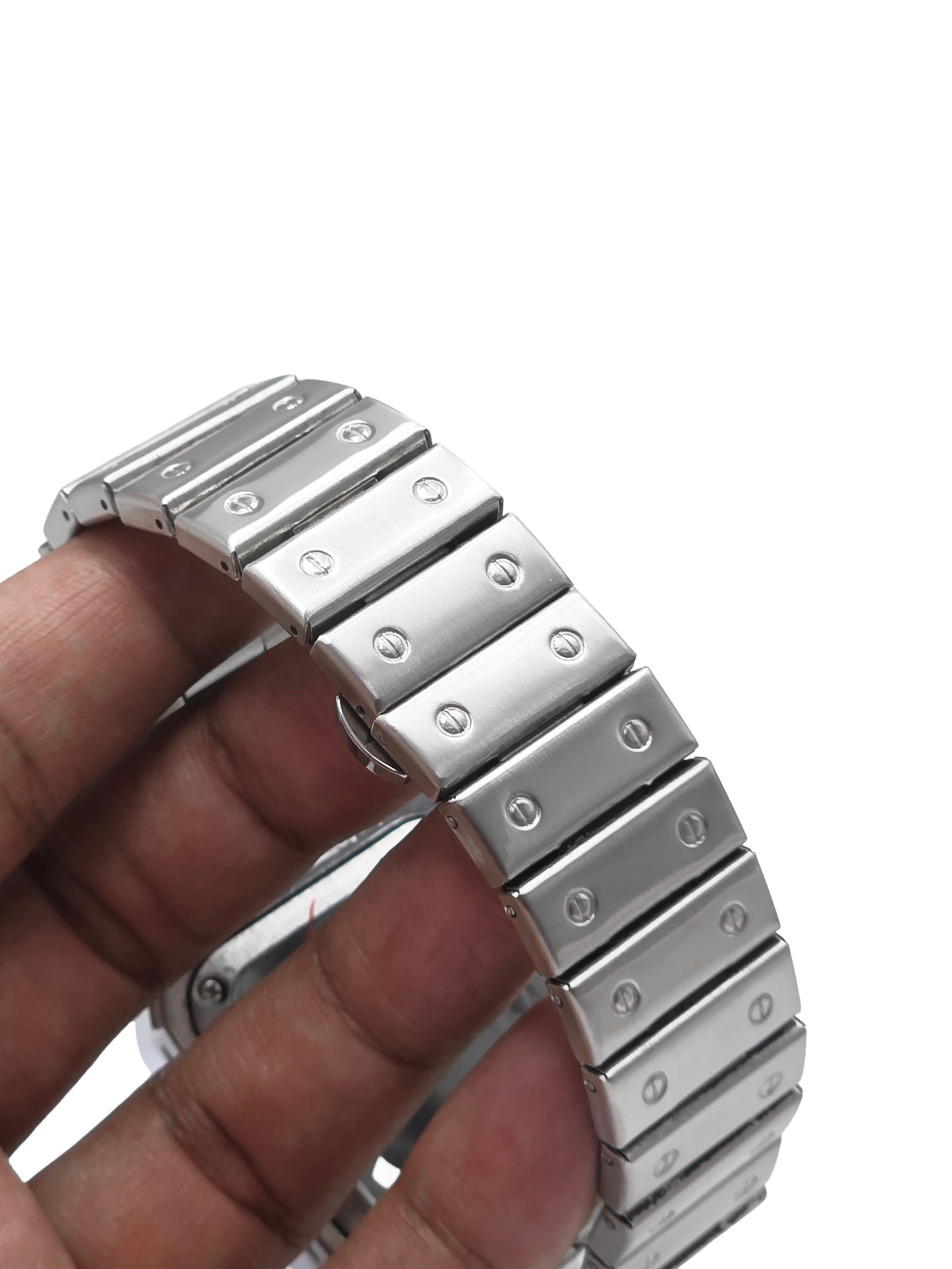 Metallic watch band being held by a hand on a white background