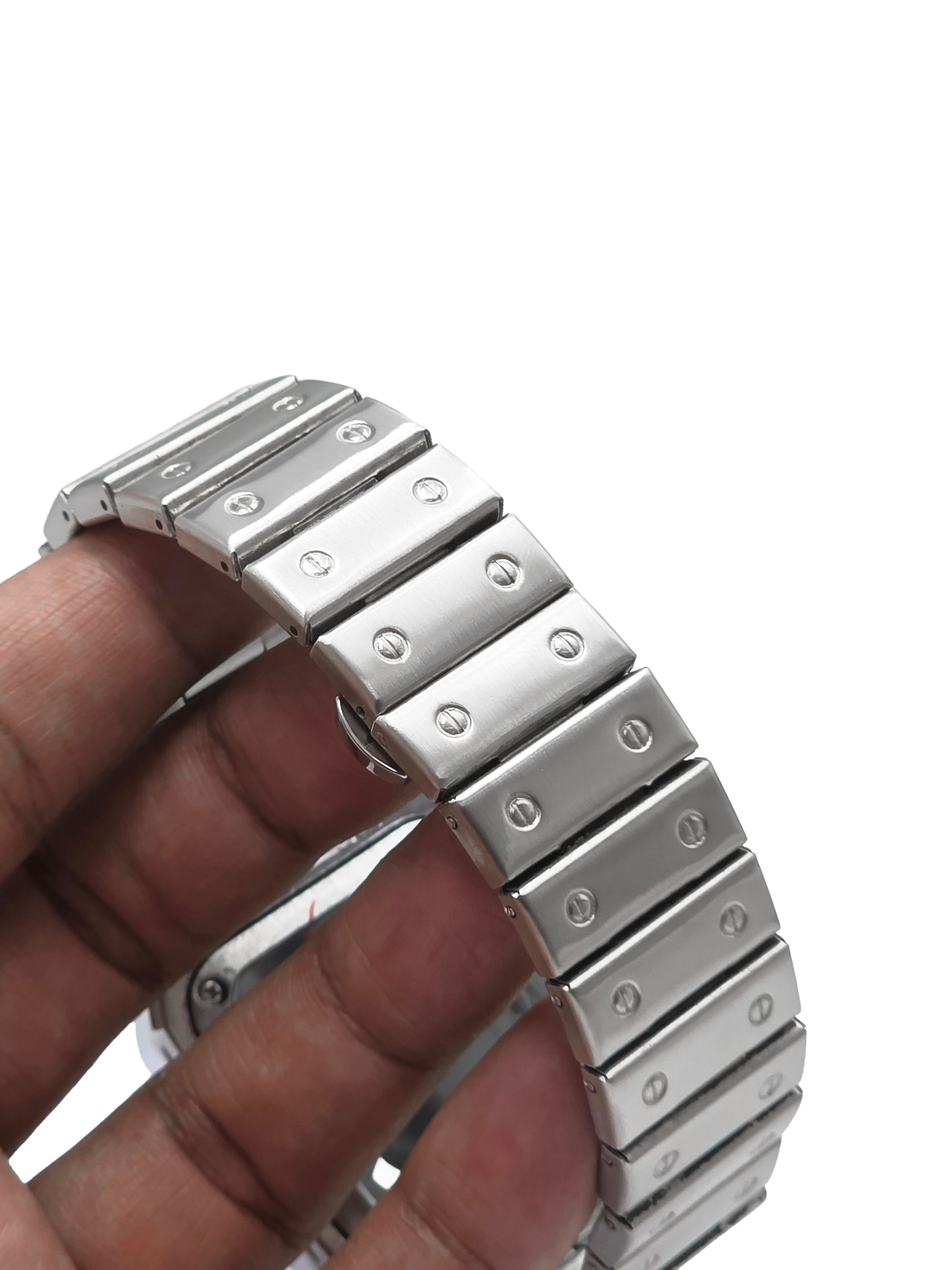 Metallic watch band being held by a hand on a white background