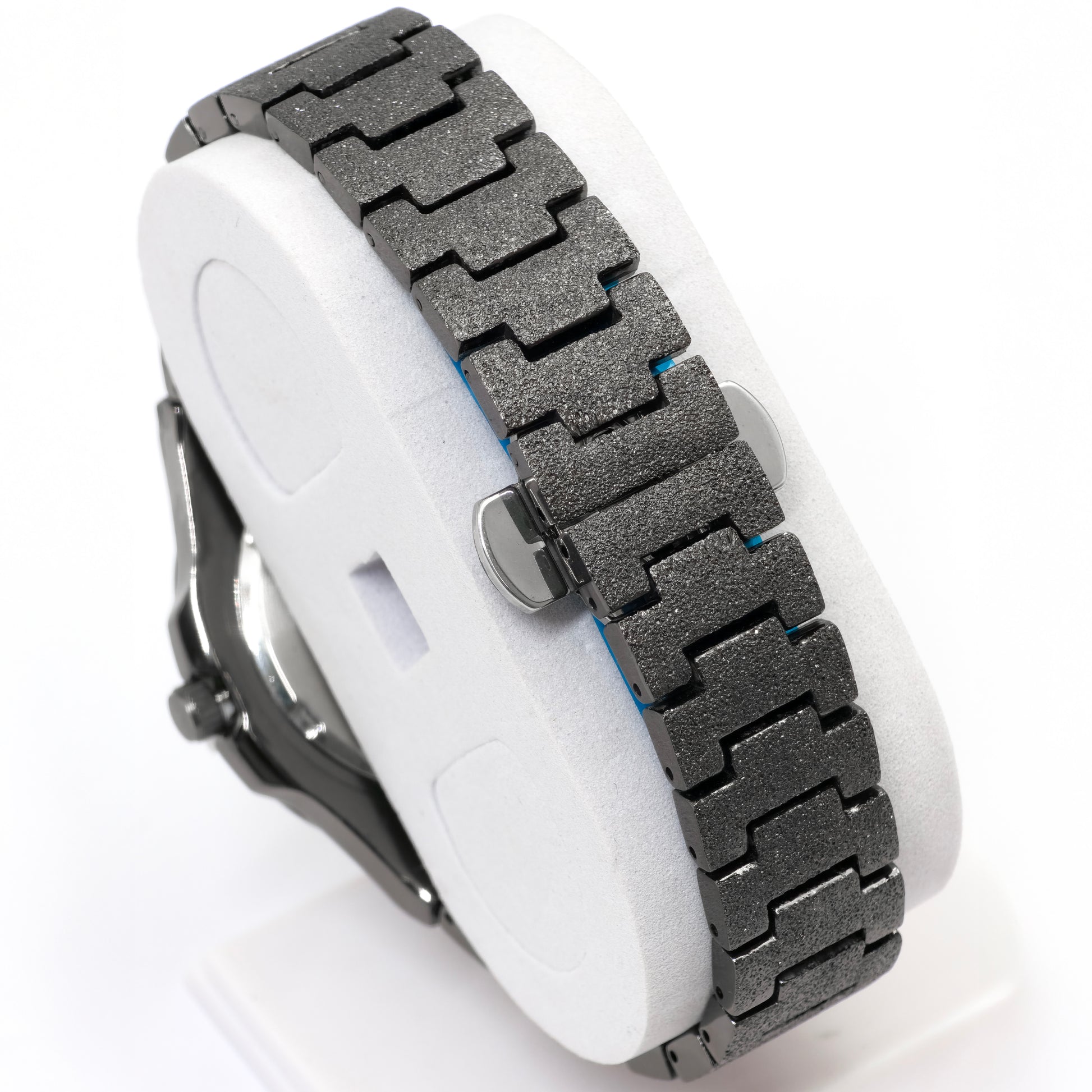 Close-up of a watch with a metallic band on a white background