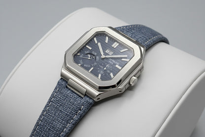 Watch with blue strap and detailed face on a dark background