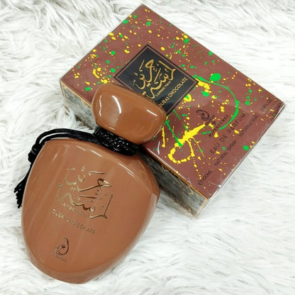 Brown ceramic item with decorative box on a white textured surface