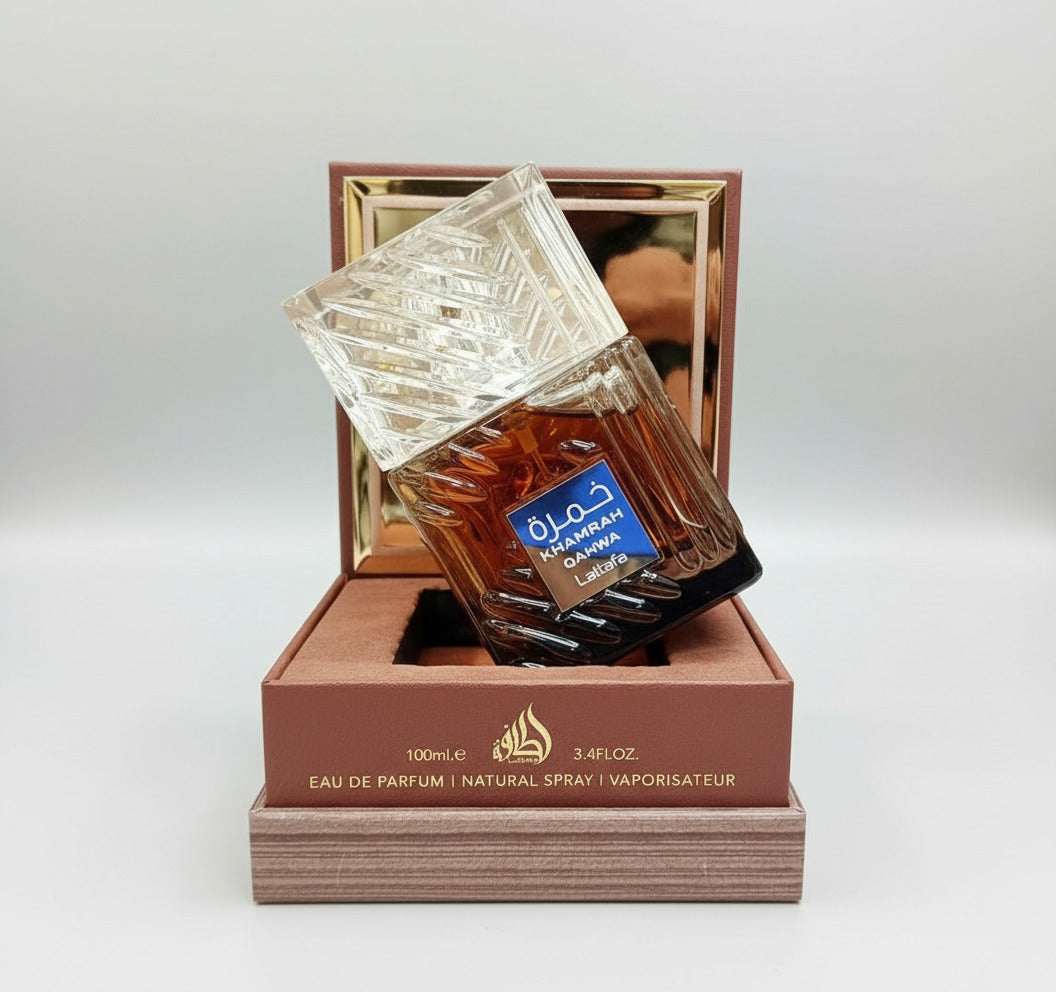 Perfume bottle with a decorative box on a blurred background