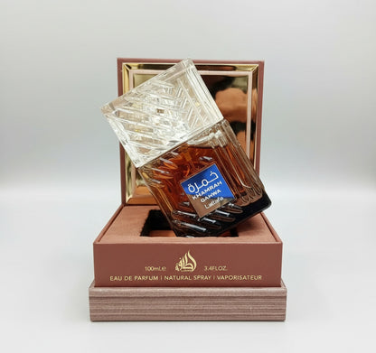 Perfume bottle with a decorative box on a blurred background