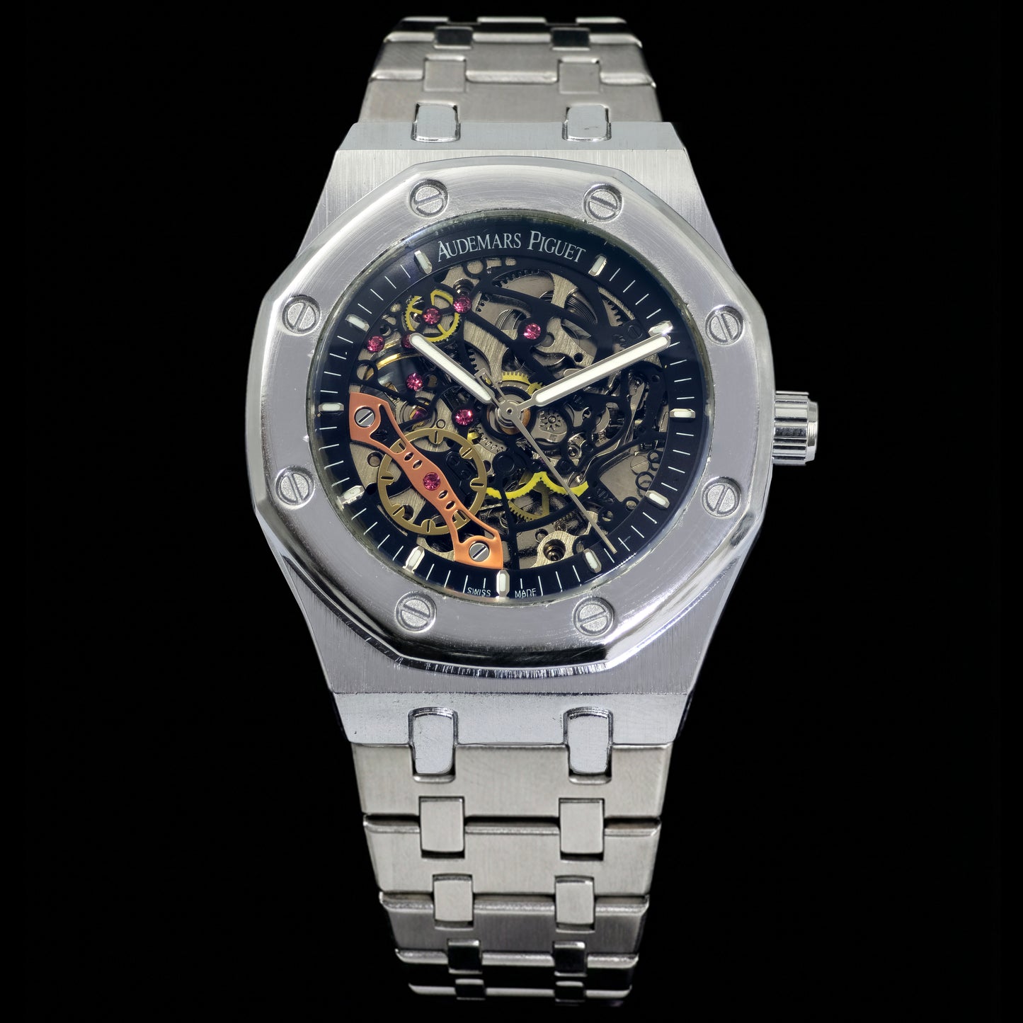 Silver watch with a detailed face on a black background