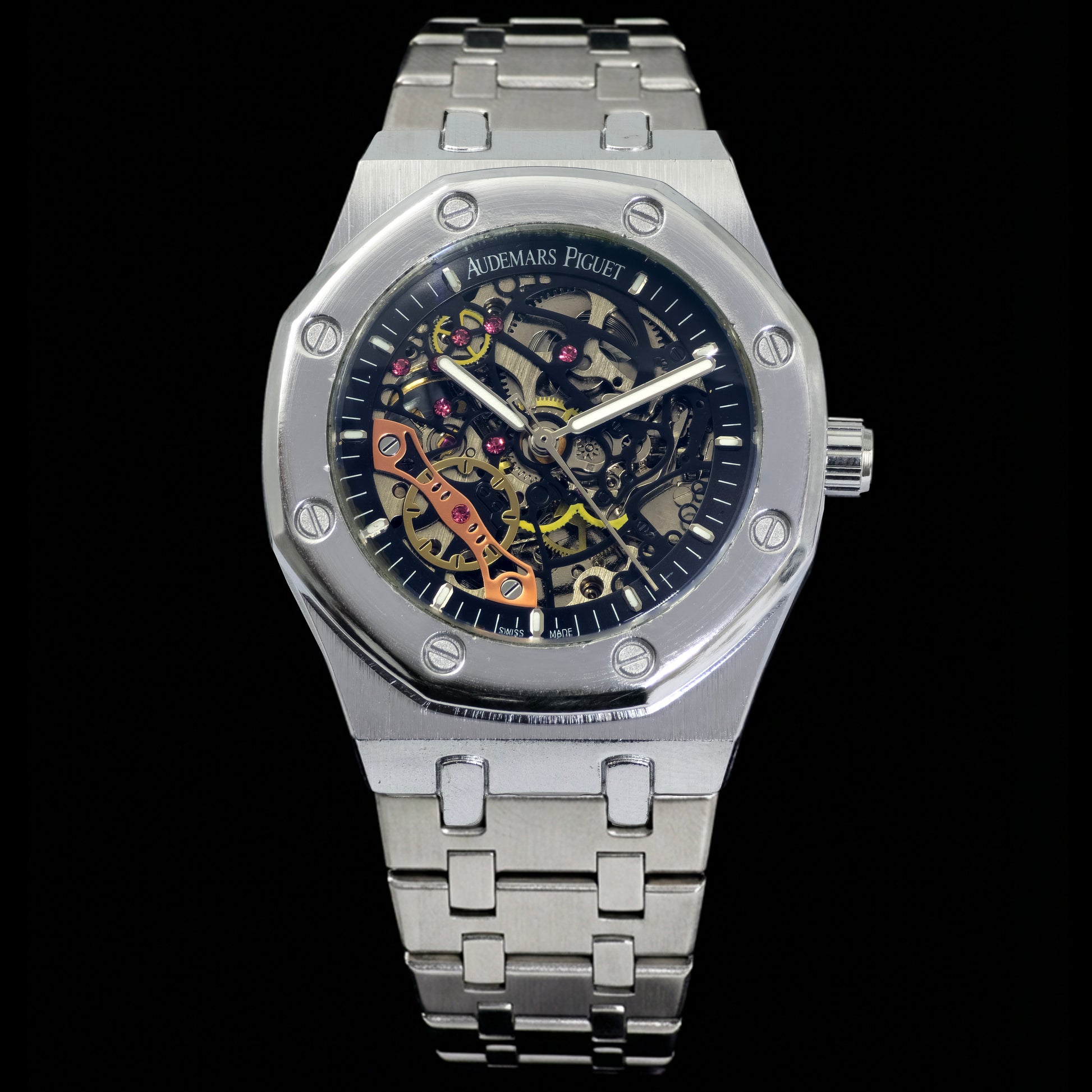 Silver watch with a detailed face on a black background