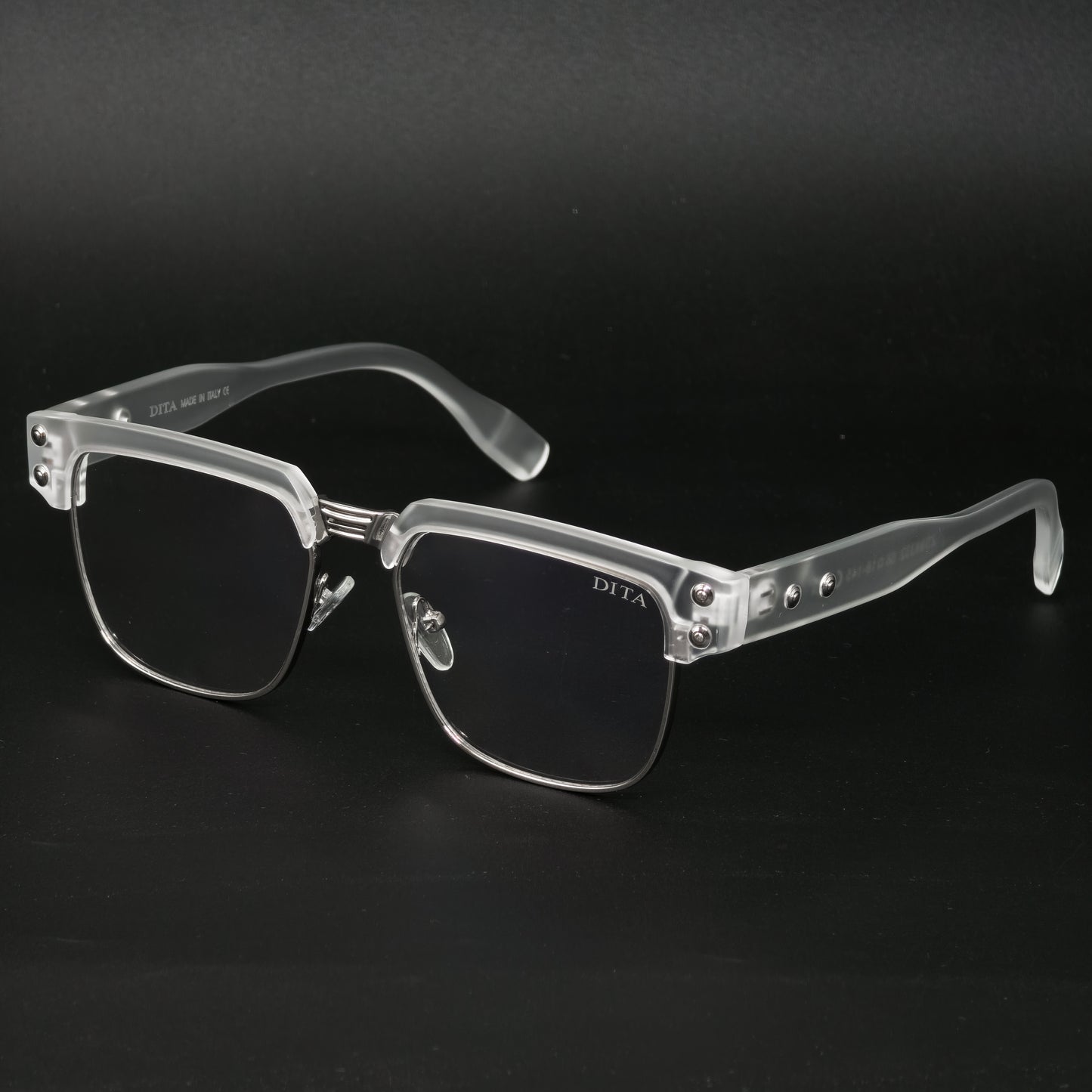 Clear eyeglasses with silver accents on a black background