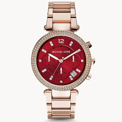 Michael Kors watch with red face and rose gold band on a white background