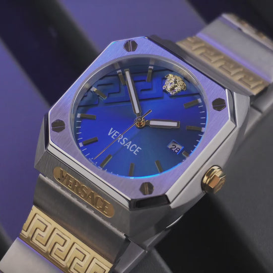 Versace watch with blue face and gold accents on a wooden surface
