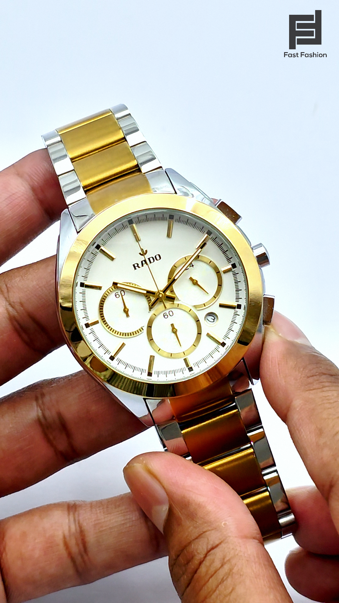 A RADO chronograph watch with a silver and gold-colored case, featuring a white watch face and a steel strap.