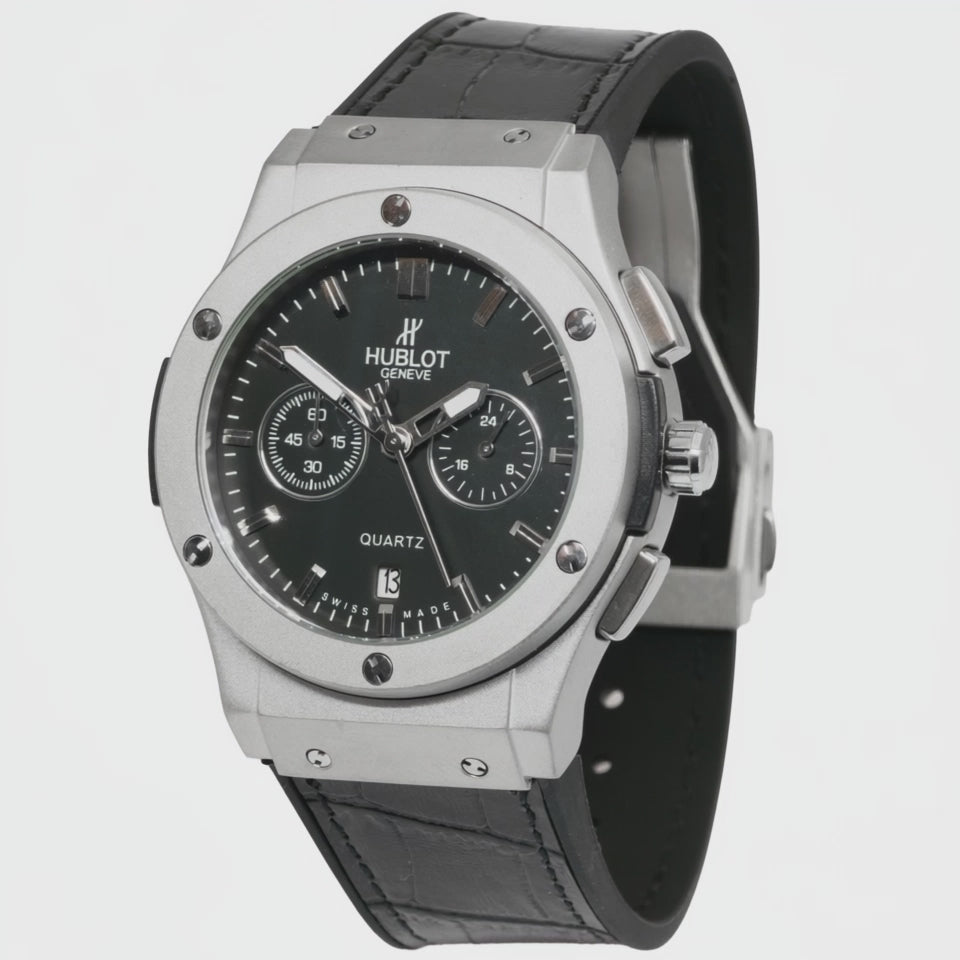 Hublot watch with black face and leather strap on a white background