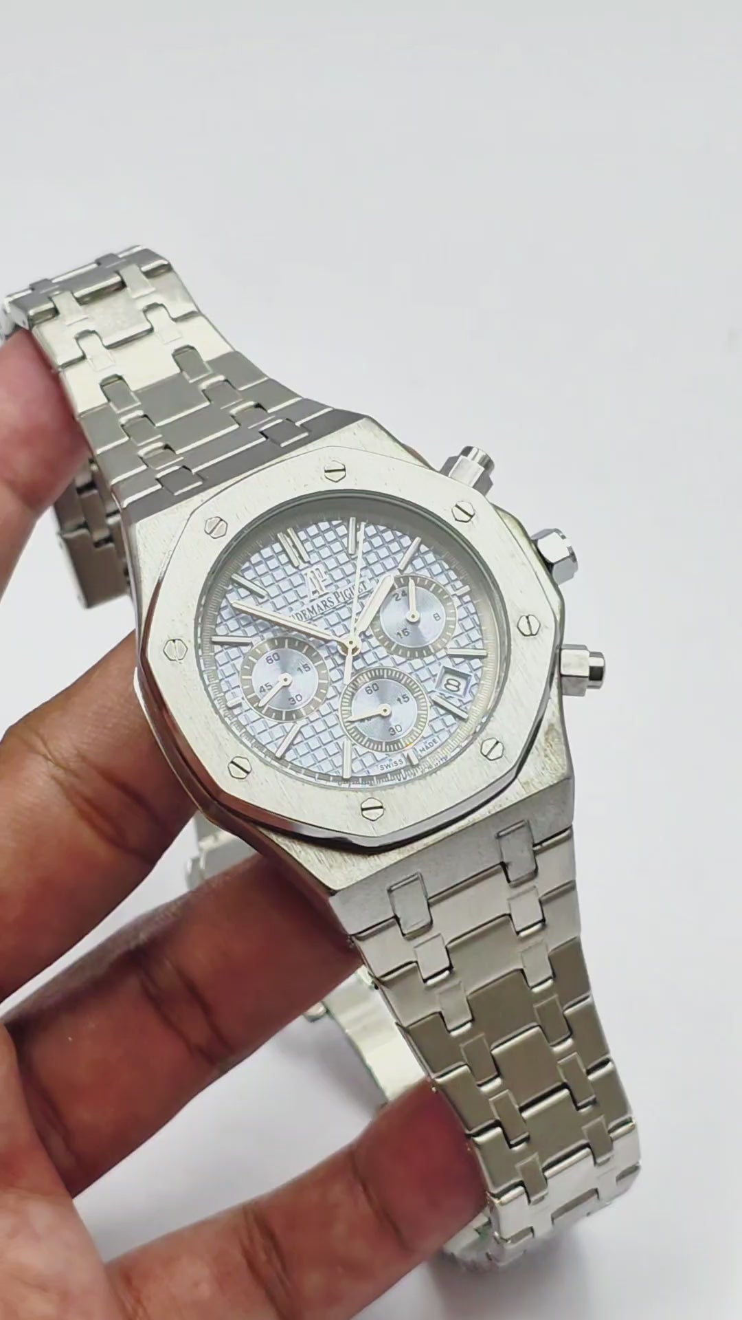 An Audemars Piguet quartz watch with a stainless steel band and a blue dial featuring multiple subdials and a date display.